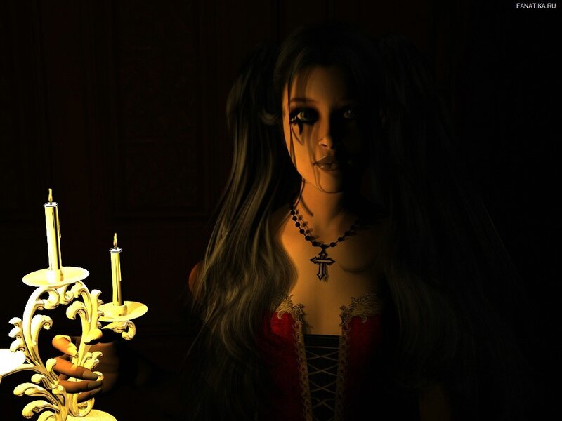 woman with candle in dark room