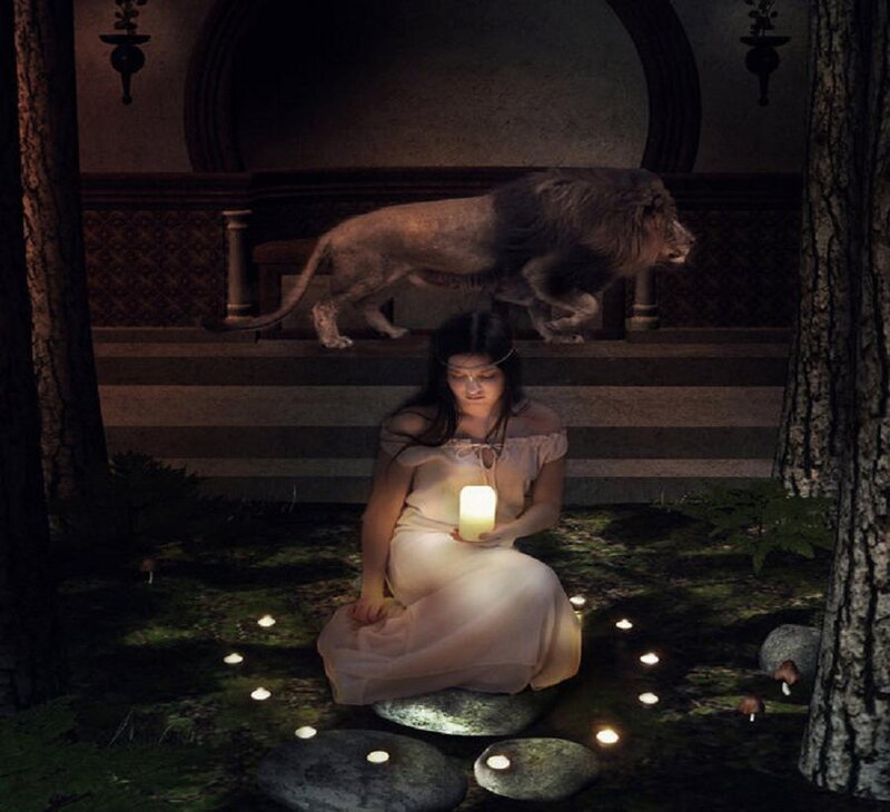 Woman with candle in forest