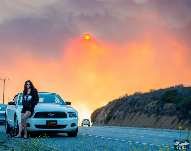 Woman with car at sunset