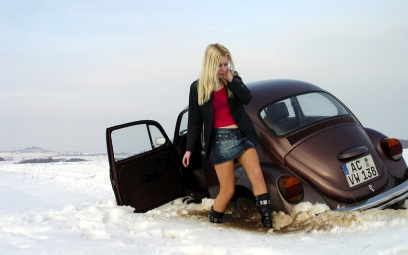 Woman with car in snow