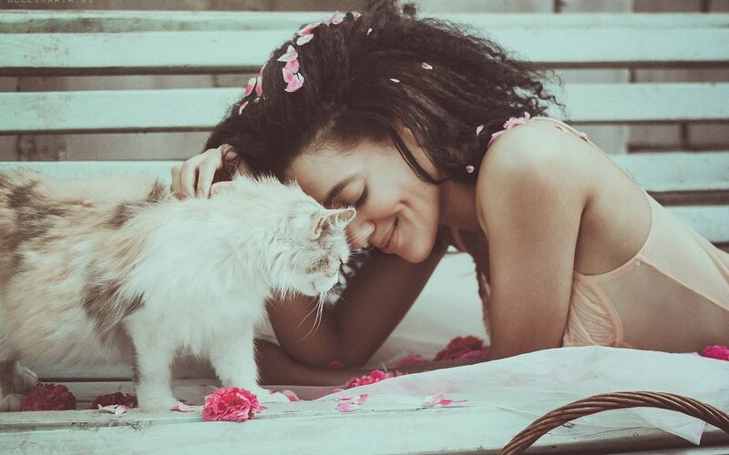 woman with cat and flowers
