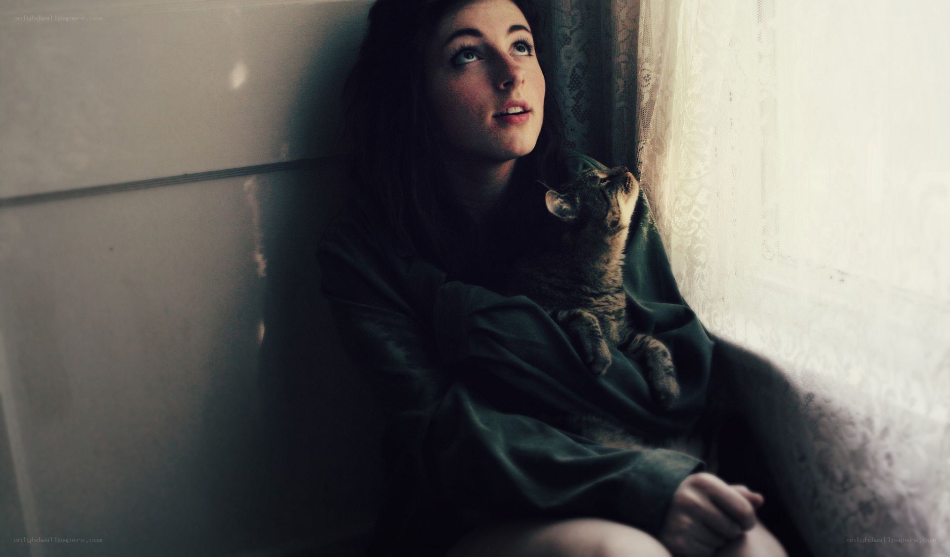 woman with cat by window