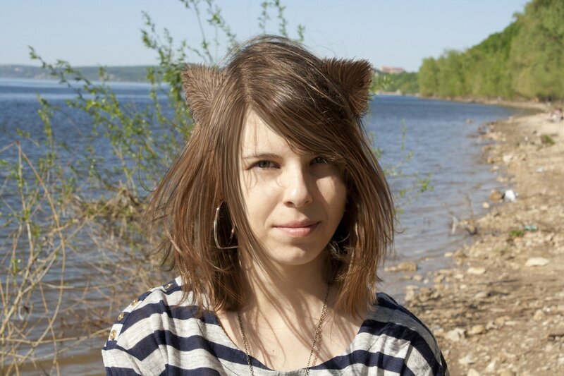 woman with cat ears by the water