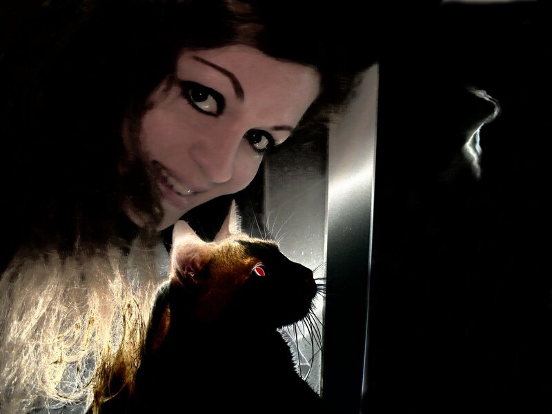 woman with cat in dark room