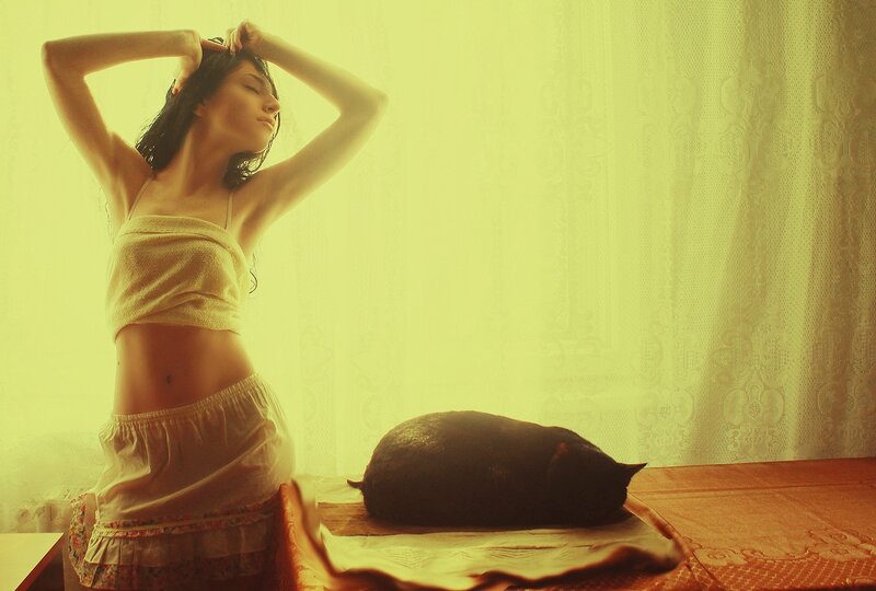 woman with cat in yellow light