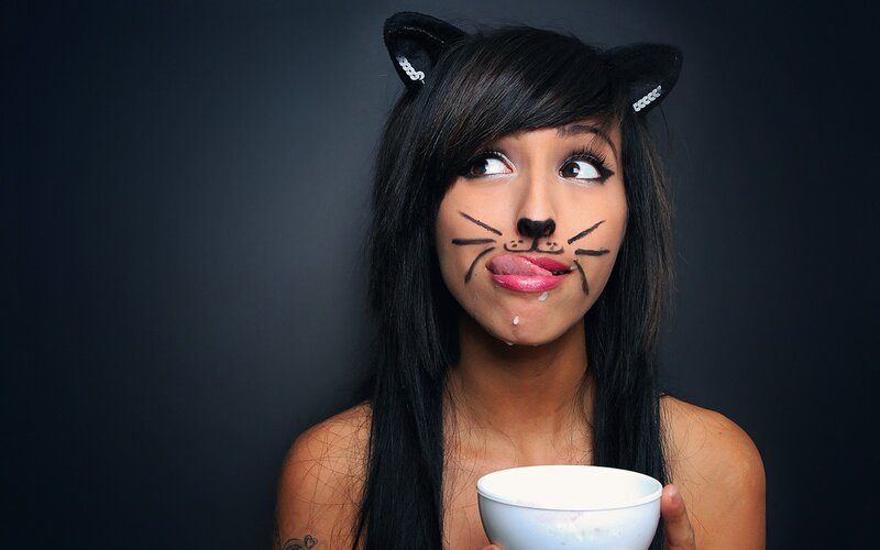 woman with cat makeup holding bowl