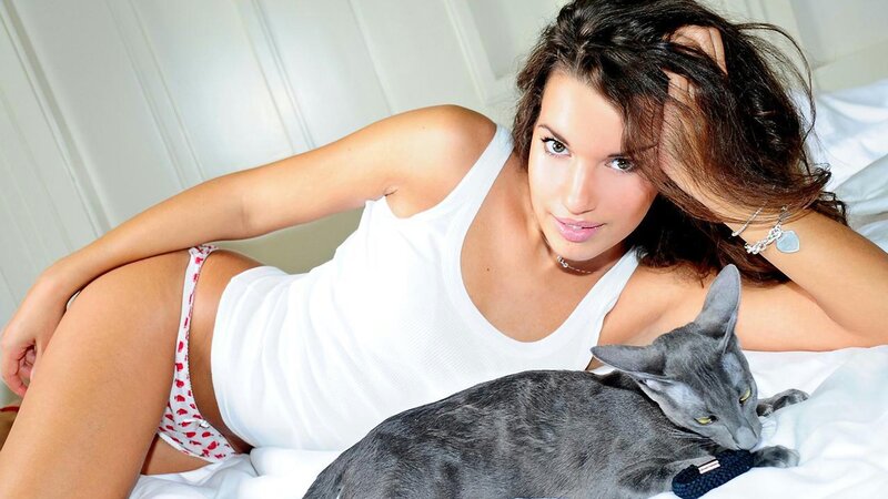 woman with cat on bed