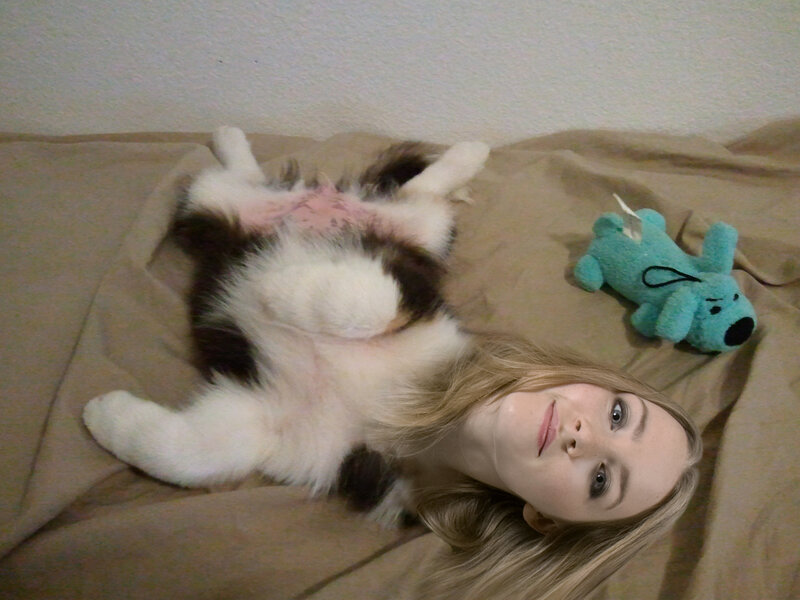 Woman with cat on bed