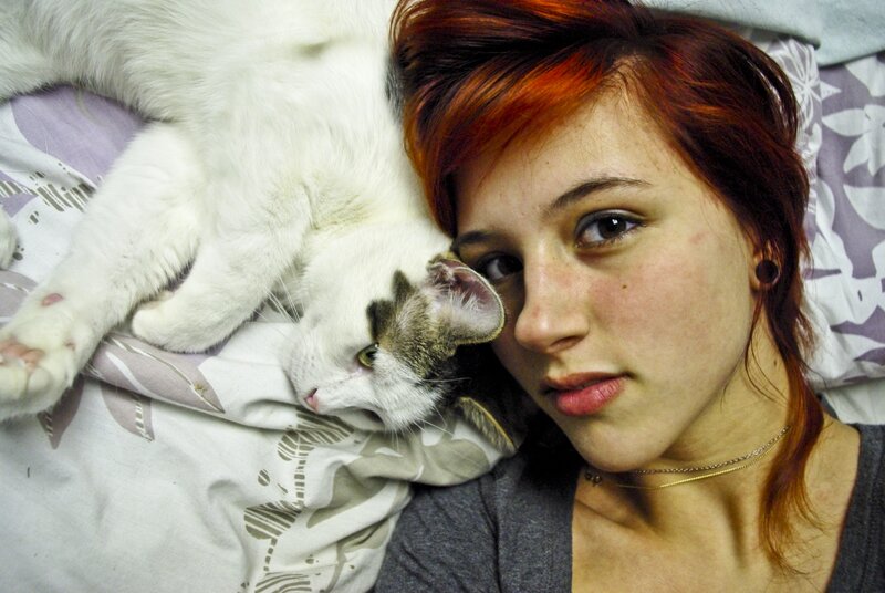 woman with cat on bed