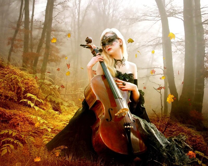 Woman with cello in autumn forest