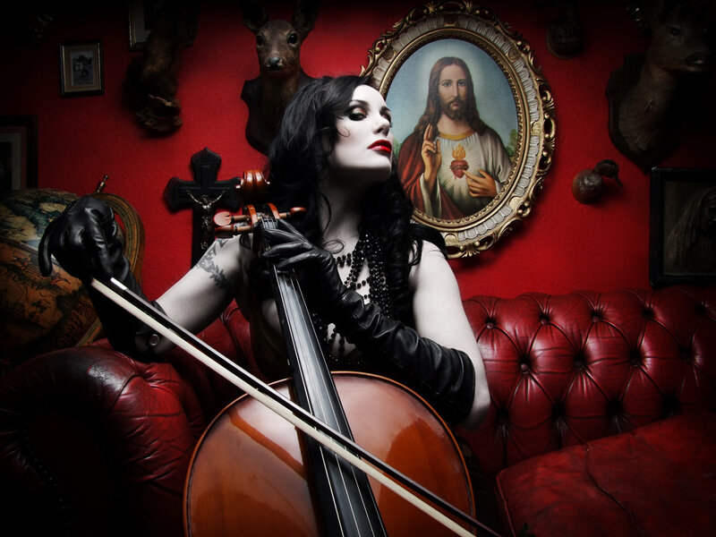 Woman with cello in red room