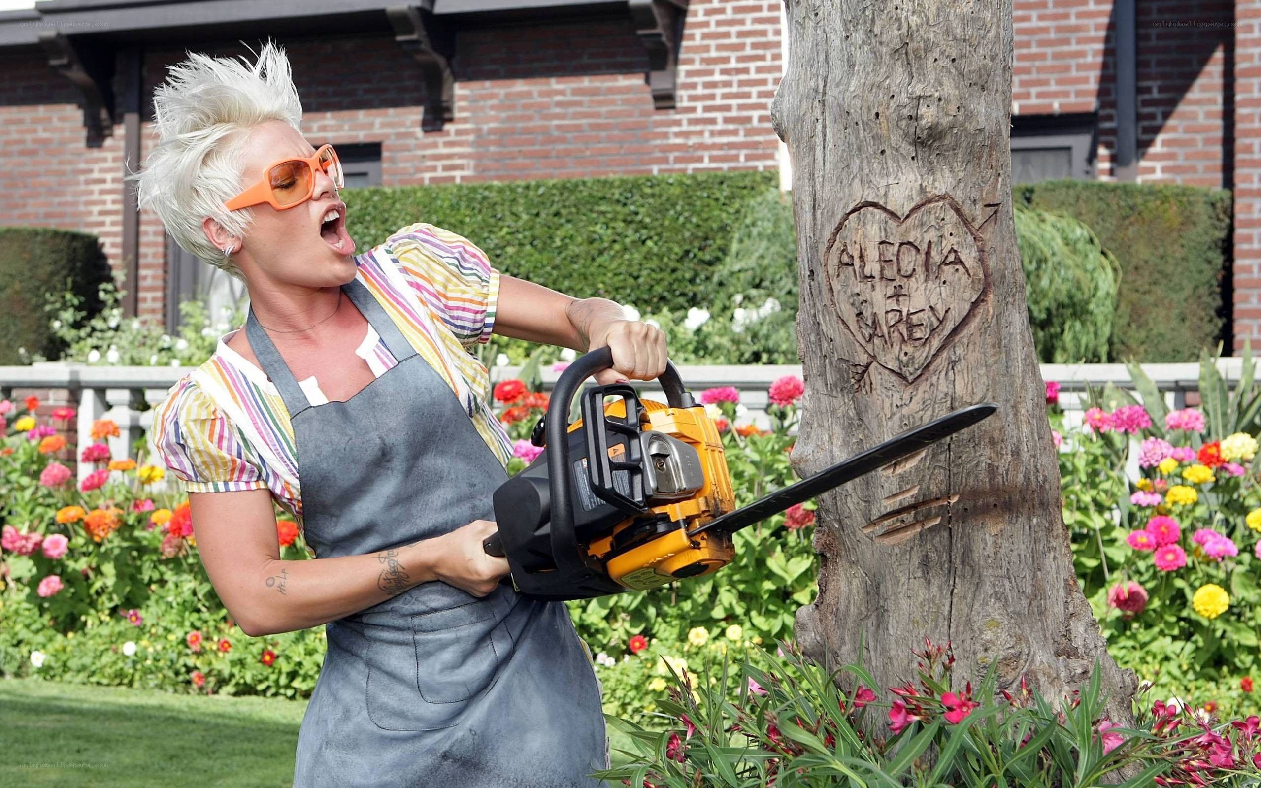 Woman with chainsaw carving tree