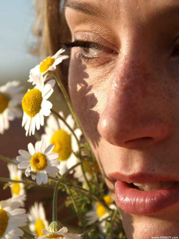 woman with chamomile flowers