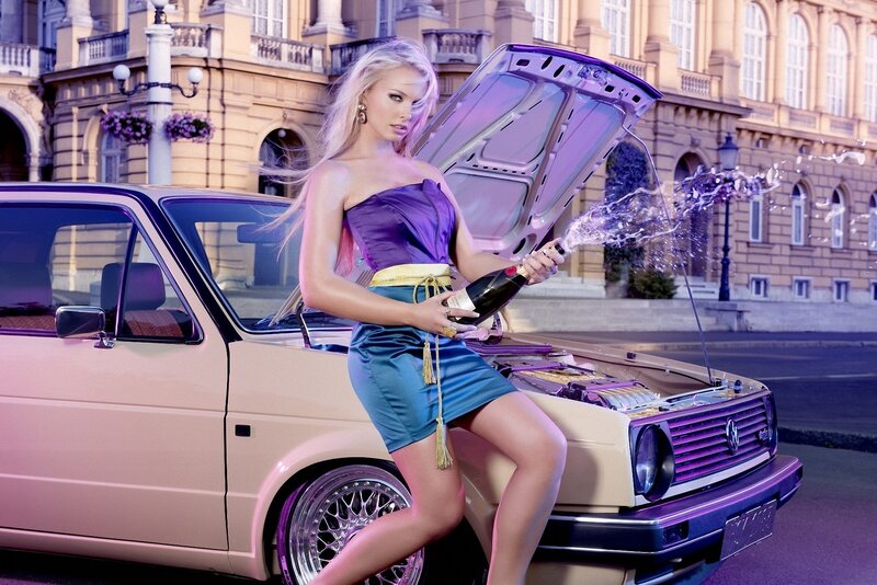 Woman with champagne by car