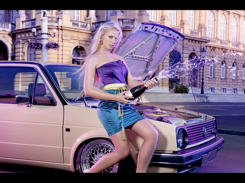 Woman with champagne by car