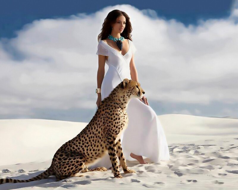 woman with cheetah in desert