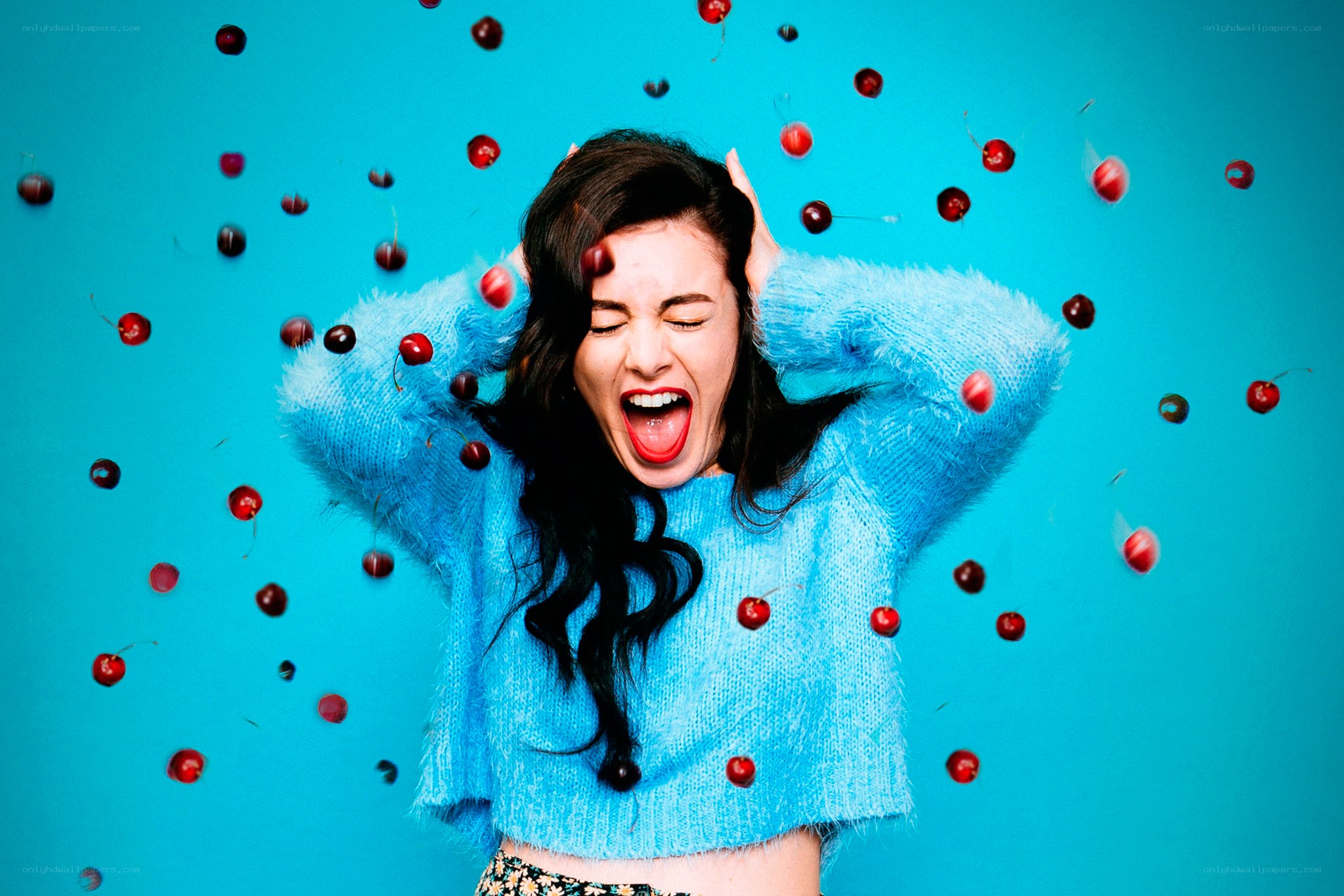 woman with cherries falling