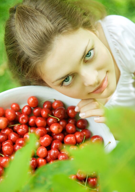 woman with cherries in garden