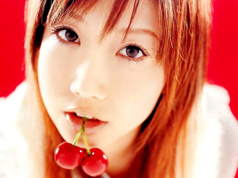 woman with cherries in mouth