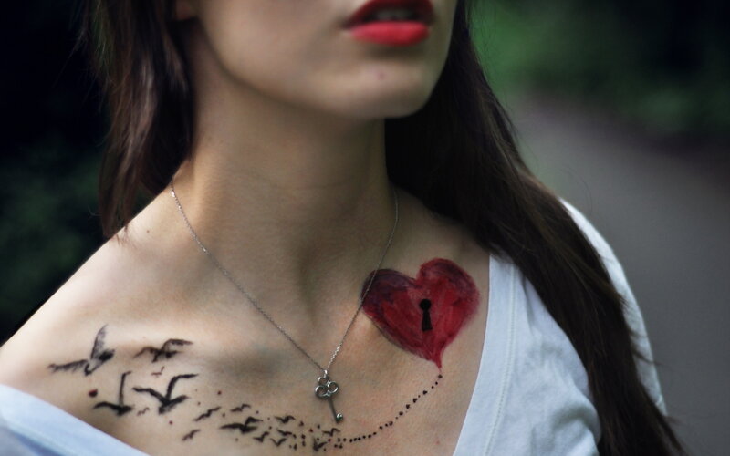 Woman with Chest Tattoos — Red