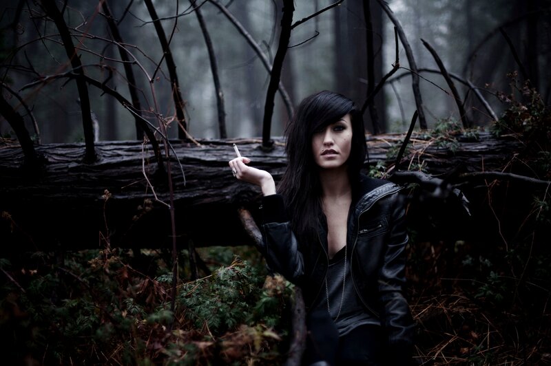 Woman with cigarette in forest