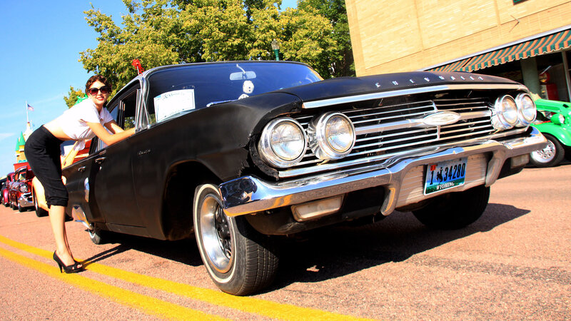 Woman with classic black car