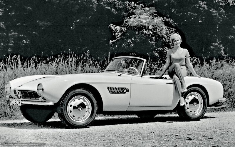 Woman with classic BMW convertible