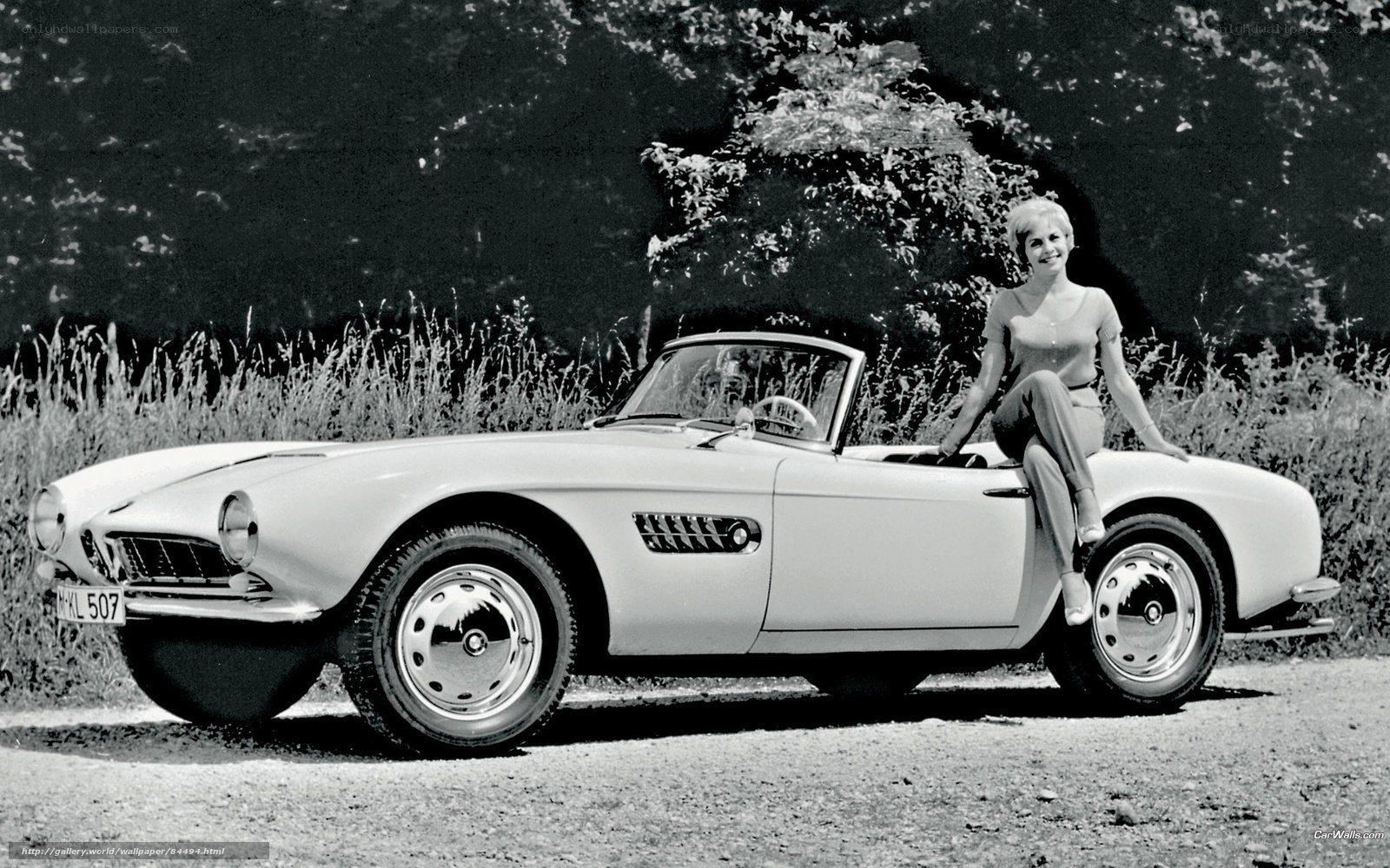 Woman with classic BMW convertible