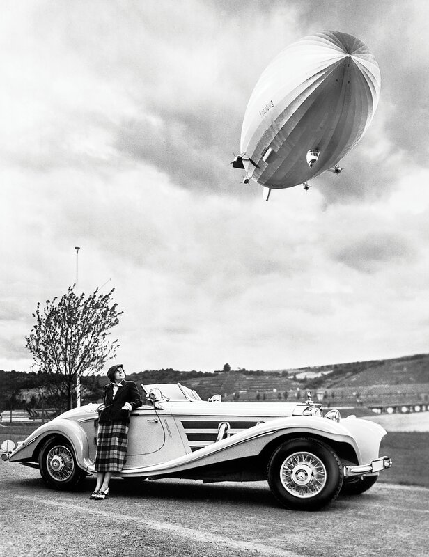 Woman with classic car and airship