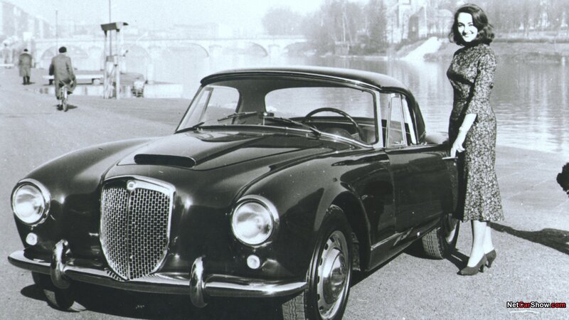 Woman with classic car by river