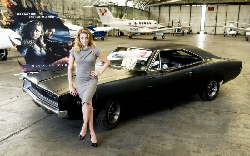 Woman with classic car in hangar