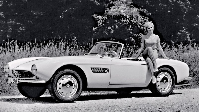 Woman with classic convertible