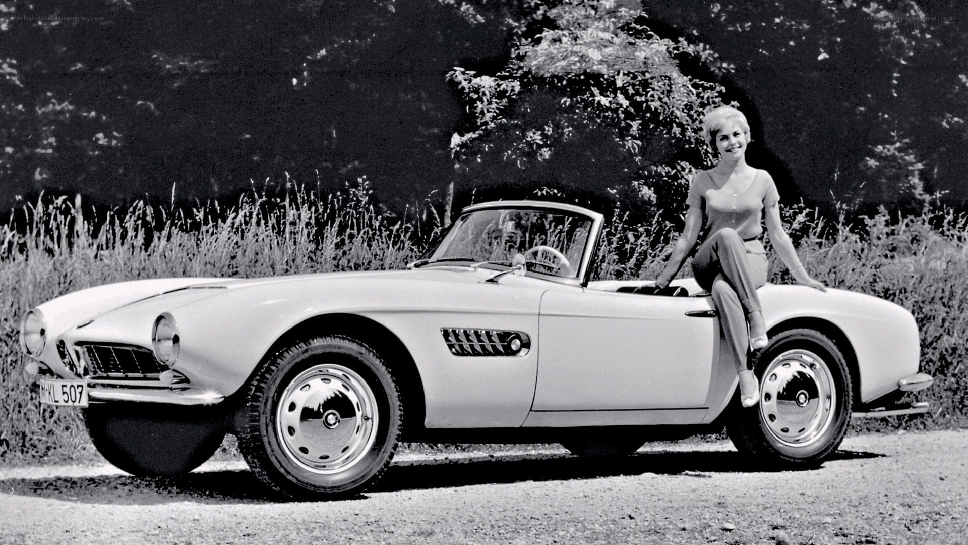 Woman with classic convertible