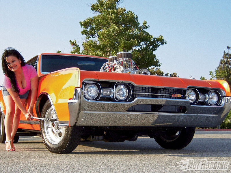 Woman with classic hot rod car