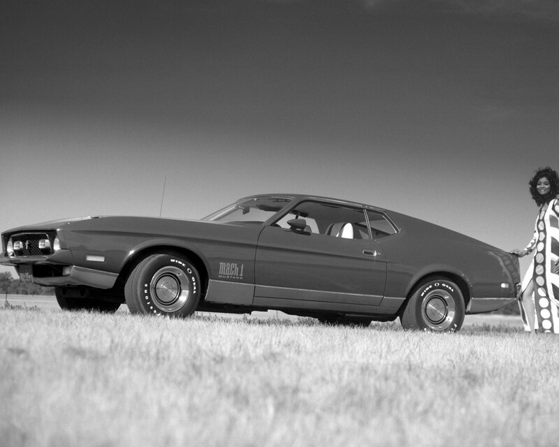 Woman with classic muscle car