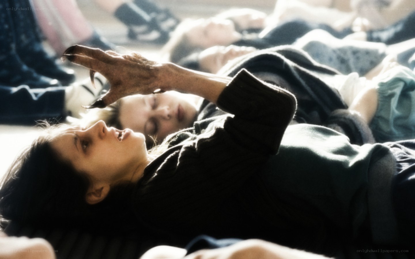 Woman with clawed hand lying down