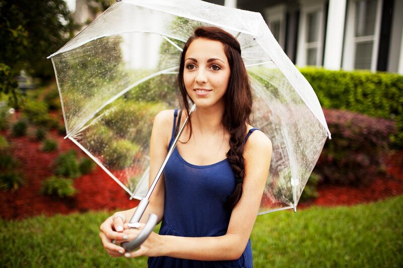 woman with clear umbrella in garden