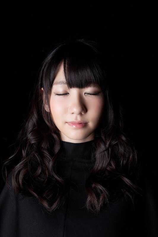 woman with closed eyes in black