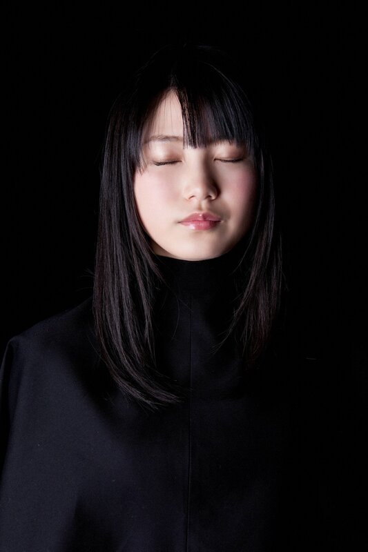 woman with closed eyes in black