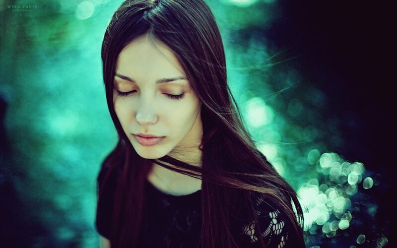 woman with closed eyes in green light