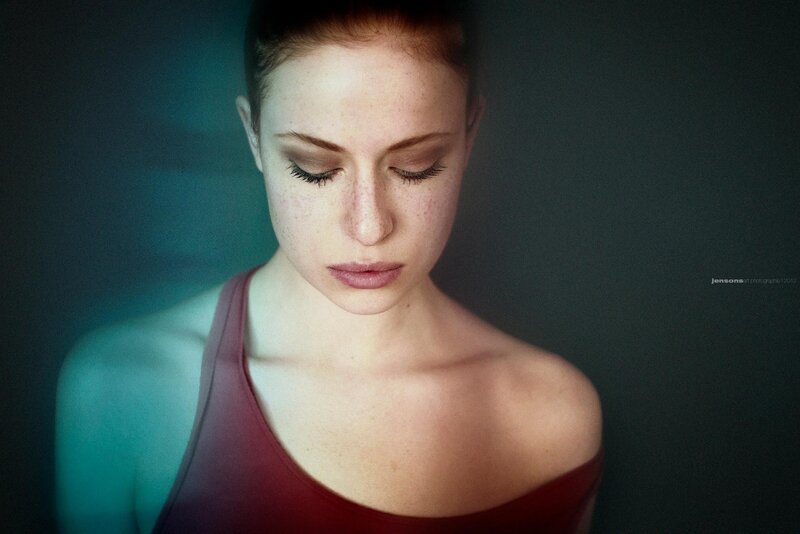 woman with closed eyes in red top