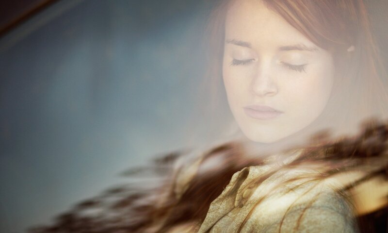 woman with closed eyes in soft light