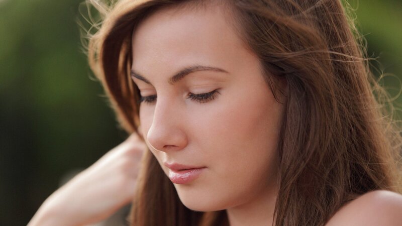 woman with closed eyes outdoors