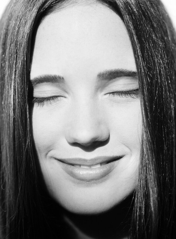 woman with closed eyes smiling