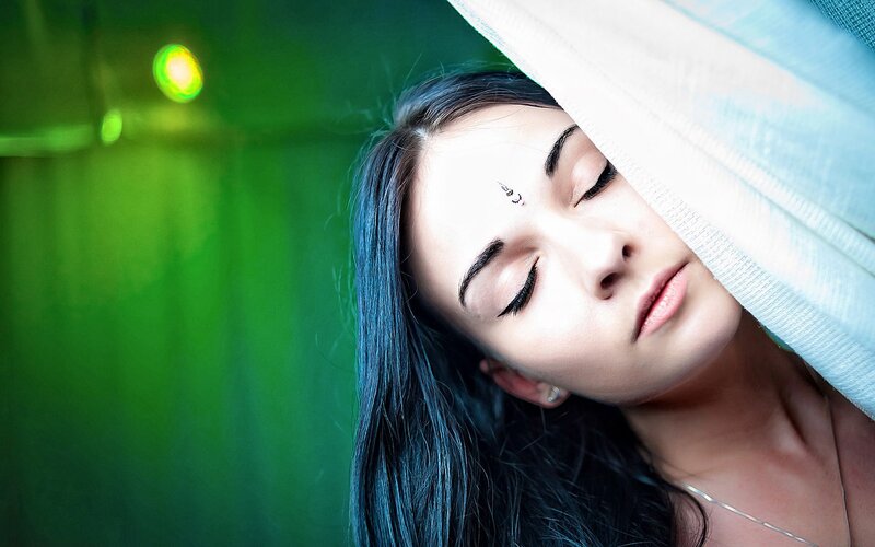 woman with closed eyes under cloth