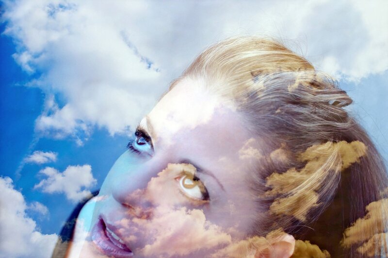 woman with clouds in her face