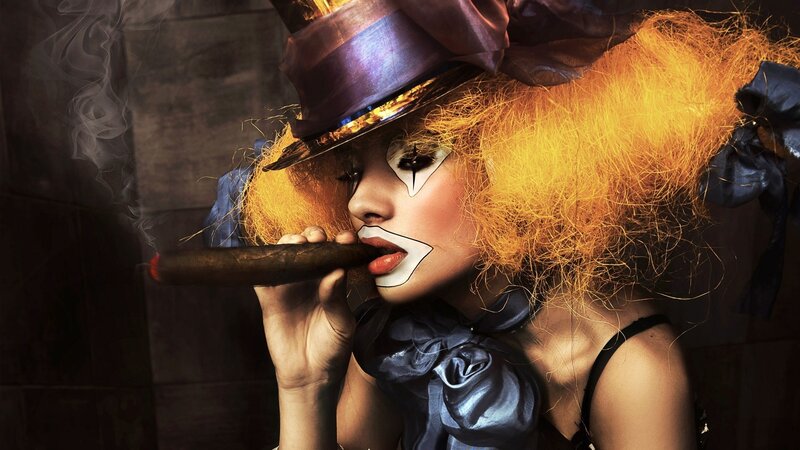 woman with clown makeup smoking cigar