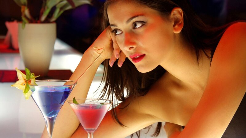 Woman with cocktails at bar