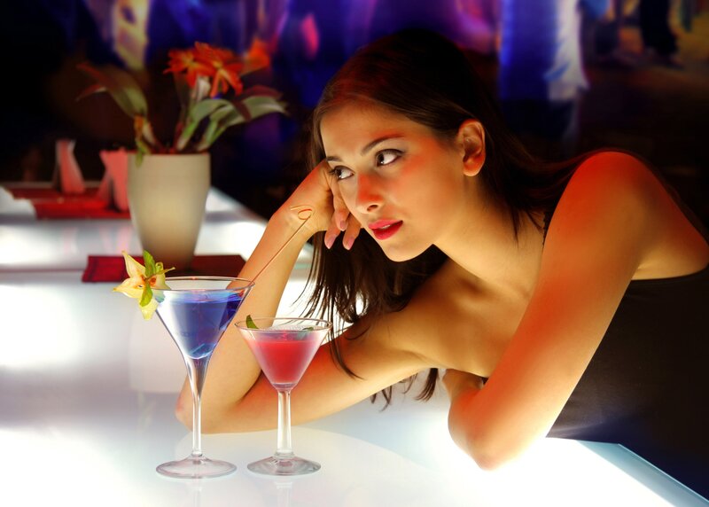 woman with cocktails at bar