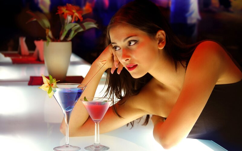 woman with cocktails at bar